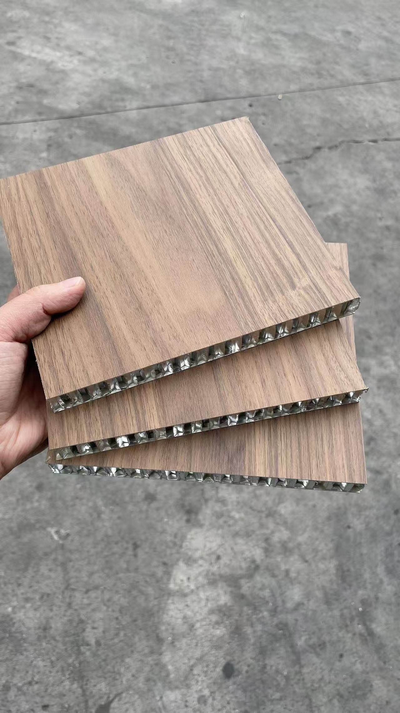 Wood-look aluminum honeycomb panel samples with exposed honeycomb edges
